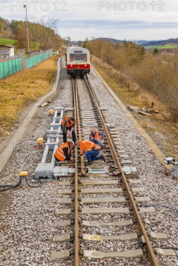 Workers carry out maintenance work on railroad tracks, historic event, first test run with a