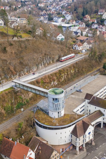 Architecture and a train on an elevated position with a view of houses and other buildings,