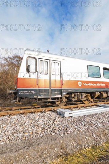 A train on rails under a blue sky with inscriptions visible on the wagons, historic event, first