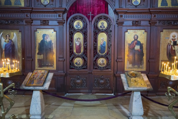A church interior with ornate icons, altars and burning candles, Svetitskhoveli Cathedral,