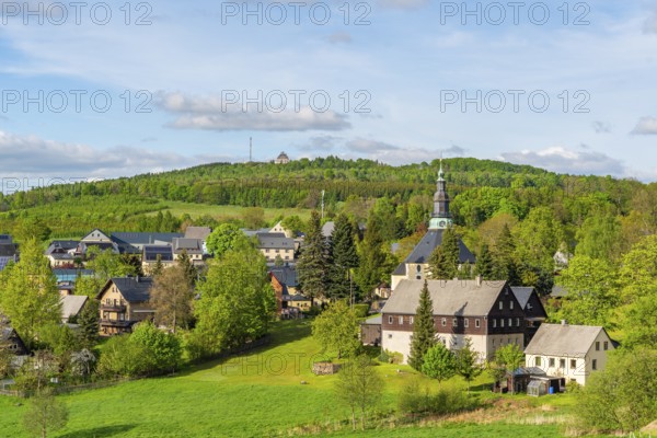 Residential buildings and landmarks of the historic mountain church, in the back forest on