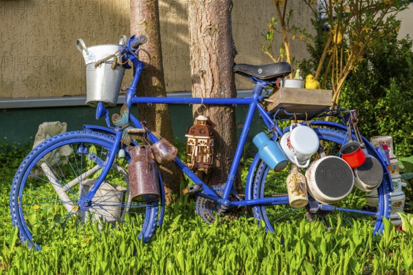 Blue painted bicycle with old pots and jugs, health resort and toy village Seiffen, Ore Mountains,