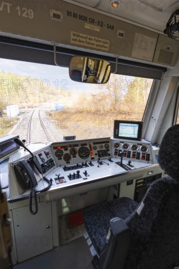 View from the train driver's cab on rails, with complex control panel and technology in the
