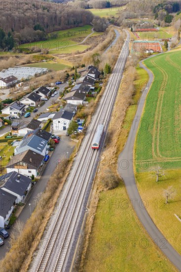 Station on a bend, surrounded by trees and fields near a settlement, historic event, first test run