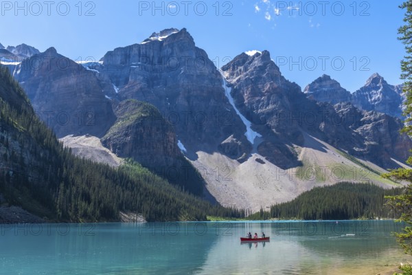 Breathtaking turquoise waters of moraine lake reflecting majestic mountains and glaciers in banff
