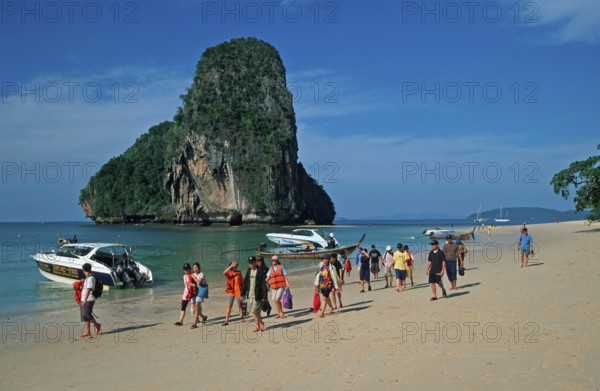 Rocks in the sea, boats and people on Pranang Cave beach, two years in front of the tsunami, Krabi,