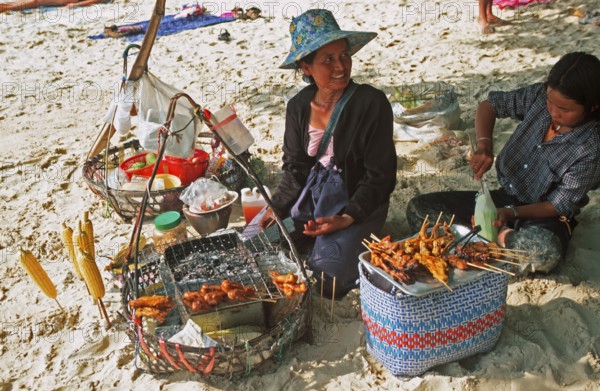 Woman and daughter with food stash on Pranang Cave beach, two years in front of the tsunami, Krabi,