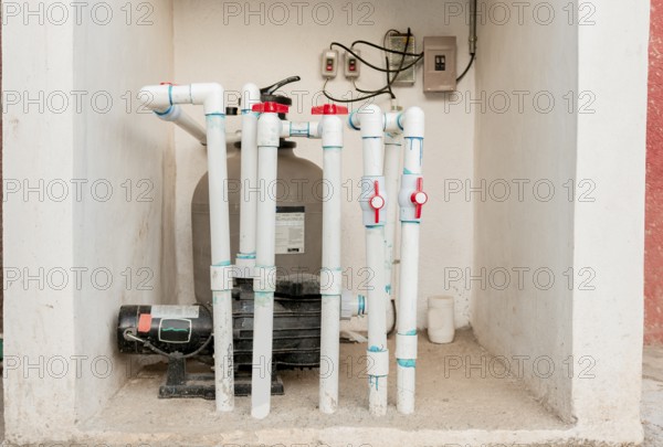 Pool pump with sand filter installed. Pool purification and maintenance system. Home pool filter