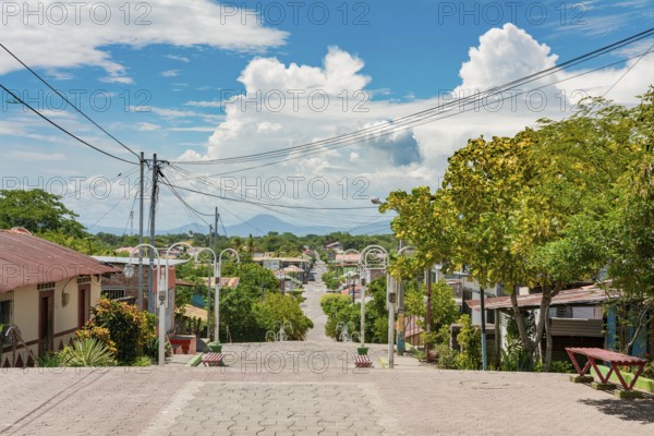 Streets of Nagarote with a view of the momotombo volcano on a suny day. View of the streets of