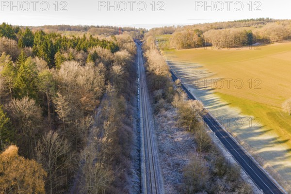Railway line between trees and a country road surrounded by nature, construction of the Hermann