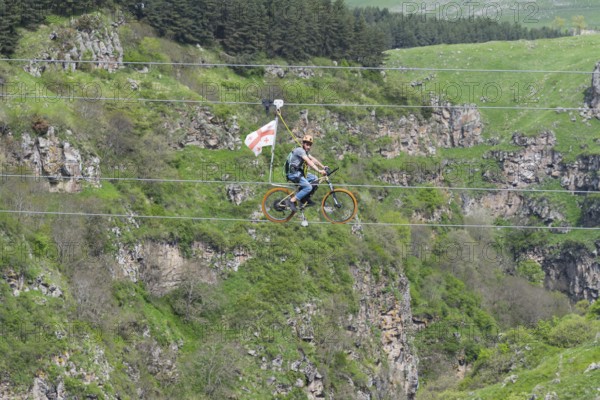Adventurous bicycle ride on a rope through a distinctive rocky landscape, Dashbashi Gorge, Khrami
