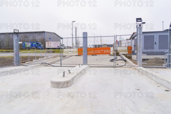 Closed construction site with concrete floor in an industrial environment, parking garage