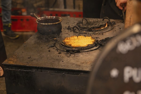 Waffles are freshly prepared on a hot oven at a market stand, Weihnachtsmark Nagold, LandkreiScalw,
