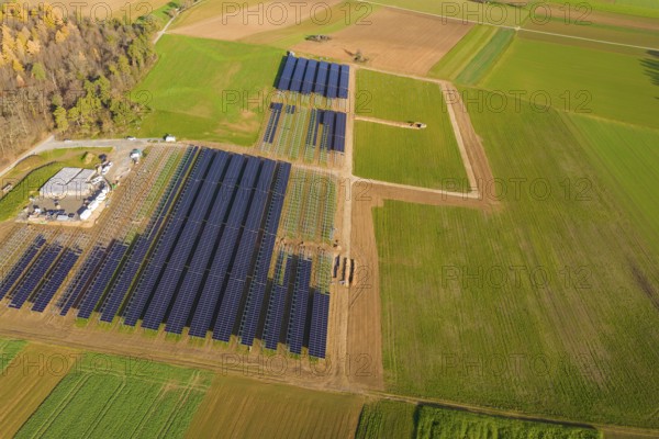 Extensive solar system in the midst of green and autumnal fields from the air, energy revolution,