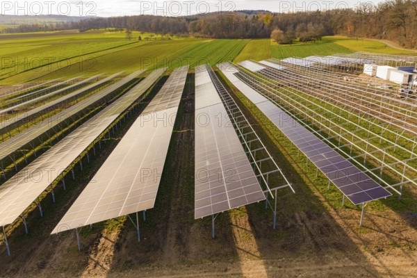 Rows of solar panels arranged in green fields, energy revolution, construction of PV open space,