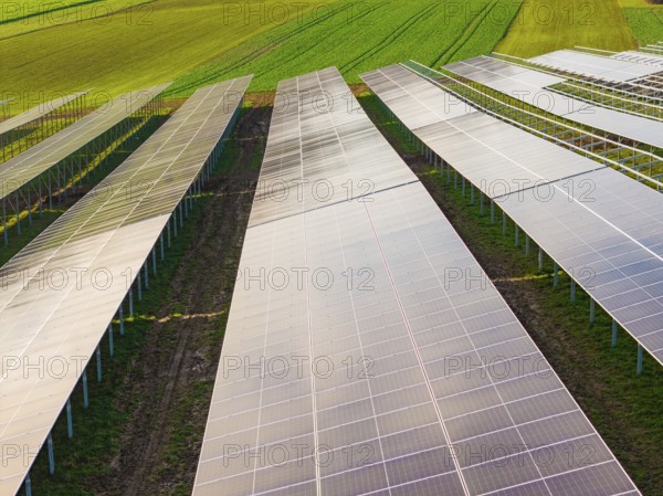 Close-up of solar systems spanning fields, energy transition, construction of PV open space,