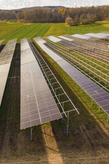 Solar cells on metal frames in a rural area, energy revolution, construction of PV open space,