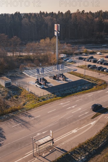 Charging station with electric car near a forest, quiet surroundings with sunset and autumn flair,