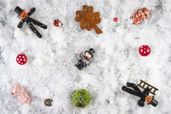 Various lucky charms and decorations on snow, New Year's Eve