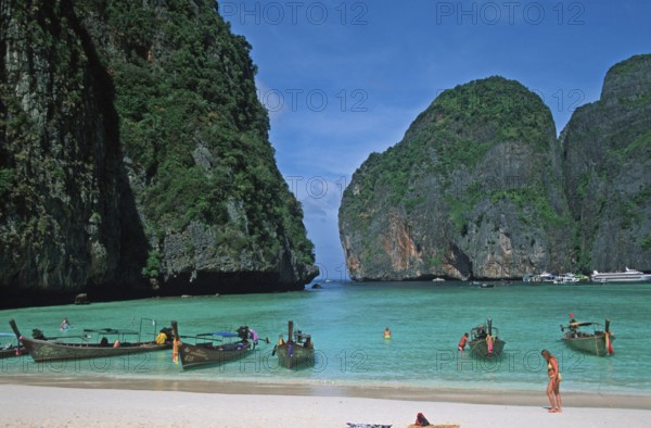 People, longtail boats on Maya Bay beach, known from the movie The Beach, one year in front of the