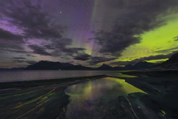 The Vestfjord in Nordland, Norway, has an enchanting atmosphere at night. Dark clouds and vivid