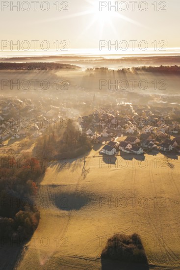 Landscape with settlement in fog at sunrise and slightly snow-covered fields, Gechingen, Calw