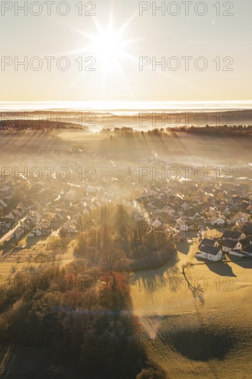 Sun-drenched settlement in fog with landscape view at sunrise, Gechingen, Calw district, Germany