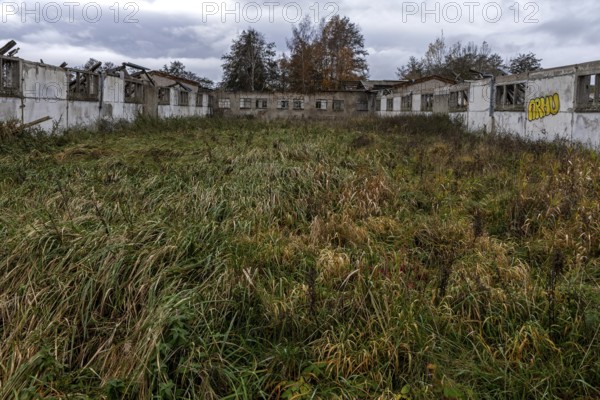 Dilapidated halls of the dilapidated plant of a former agricultural production cooperative of the