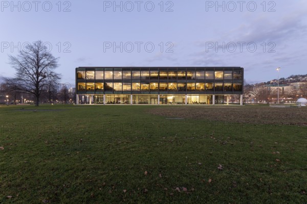 The state parliament of Stuttgart glows impressively in the evening. The architecture is