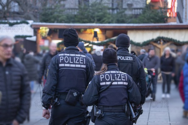Three police officers are patrolling the Stuttgart 2025 Christmas market. Their presence ensures