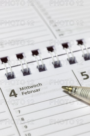 Calendar detail with ballpoint pen on a February-Wednesday page, appointment calendar