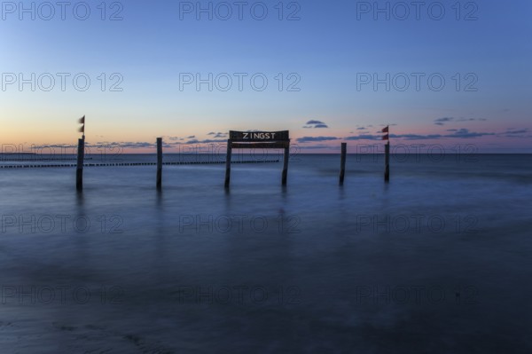 Wooden sign in the sea with inscription Zingst, long exposure, evening light, Zingst,