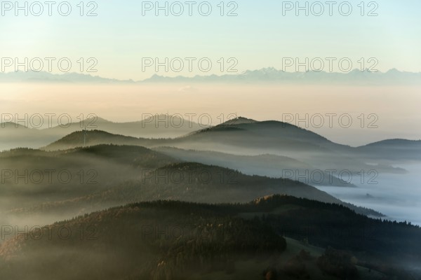 View from Belchen heading south of Wiesental and the Swiss Alps, morning atmosphere with fog in