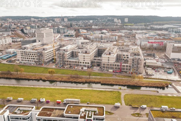 City with construction sites and river under cloudy sky, Neubau Krankenhaus, Böblingen, Germany