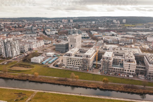 New urban development with staggered modern buildings next to a river in the foreground, Böblingen,
