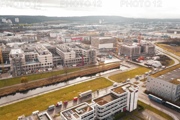 City view with modern buildings under construction along a small river in an urban area, Böblingen,