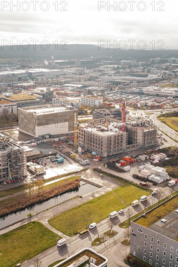 New hospital building Municipal construction site with several buildings and cranes next to green