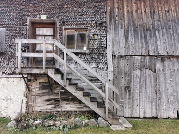 Detail of an old farmhouse in Schöllang, wooden staircase and entrance door, Illertal, Oberallgäu,