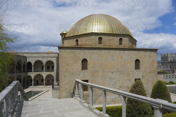 Historic building with golden dome and surrounding gardens under blue skies, Rabati Fortress,