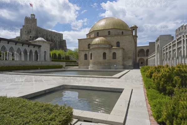 Building ensemble with golden dome, stone arcades and water basin in front of a fortress, Rabati
