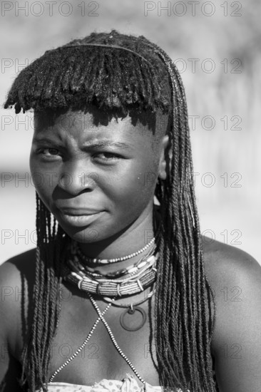 Black and white, portrait, brightly decorated woman of the Hakaona tribe, also Havakona or