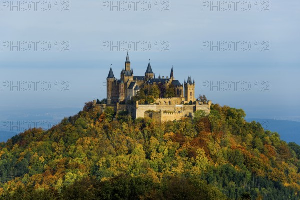 Castle and autumnal forest, Hohenzollern Castle, sunrise, Hechingen, Swabian Jura,