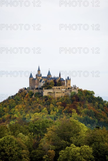 Castle and autumnal forest, Hohenzollern Castle, Hechingen, Swabian Jura, Baden-Württemberg,