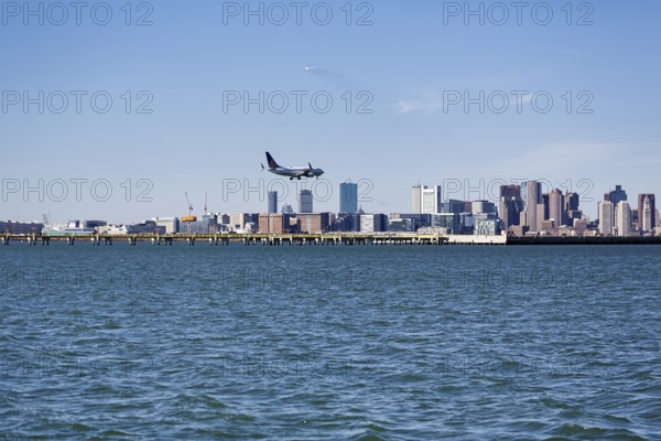 Boston skyline with an airplane landing at Logan International Airport, Boston, Massachusetts, New