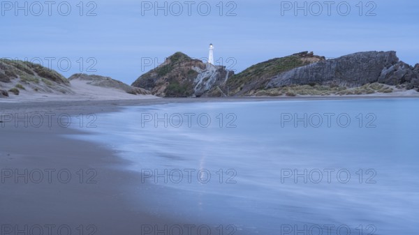 Deliverance Cove and Castlepoint Lighthouse on the rock, ocean, long exposure, evening, illuminated