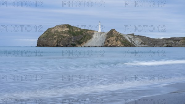 Castlepoint Beach with lighthouse on the rock, ocean, long exposure. Castlepoint, Wairarapa Coast,