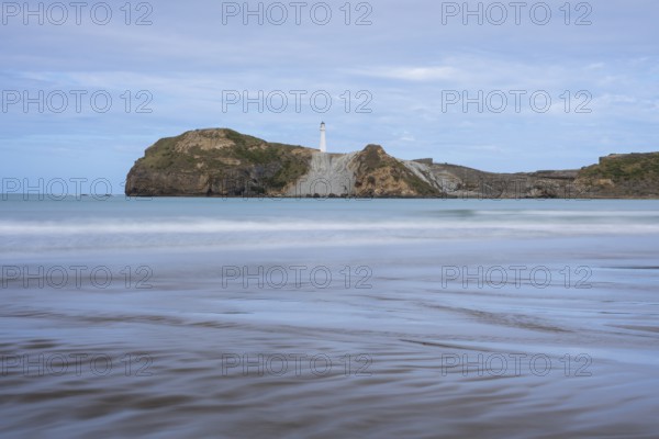 Castlepoint Beach, ocean and lighthouse on a rock, long exposure. Castlepoint, Wairarapa Coast,