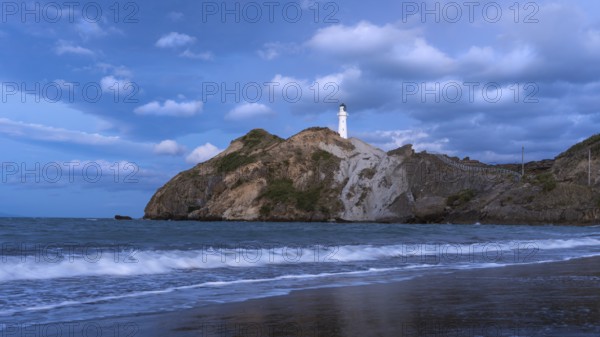 Castlepoint Beach, ocean and lighthouse on a rock, in the evening, after sunset. Castlepoint,