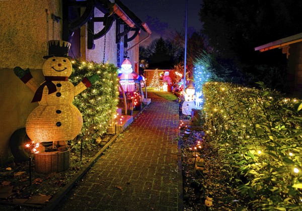 Christmassy kitschy illuminated entrance of a terraced house in Gelsenkirchen-Ückendorf in the