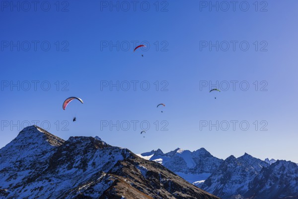 Paragliders fly over the mountains of the Valais Alps, Val d'Anniviers, Valais Alps, Canton of